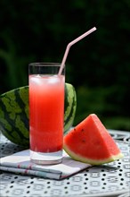 Watermelon juice in glass with drinking straw