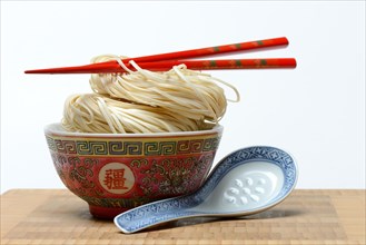 Chinese Yangchun noodles in bowl with chopsticks and porcelain spoon