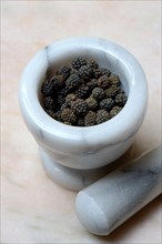 Wild Assam pepper in mortar