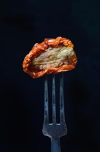 Dried tomato on fork