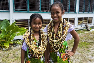 Two Girls with necklaces made of shells