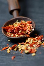 Dried chili peppers with wooden spoon