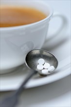 Sweetener tablets and coffee cup