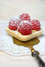 Patisserie with raspberries on a cake server
