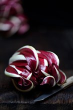 ( Cichorium intybus var. foliosum) Radicchio and kitchen knife, Radicchio Rosso di Treviso, red