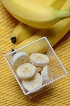 Banana slices in peel and bananas