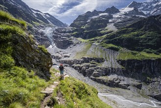 Hikers in the mountains on a hiking trail to Grindelwald