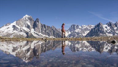 Young woman walking in front of mountain panorama