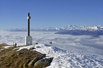 Summit cross of Monte Lema and sea of clouds over Lake Maggiore