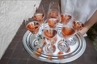 Glasses of champagne served on a silver tray