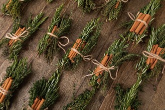 Cinnamon sticks tied together with rosemary and thyme