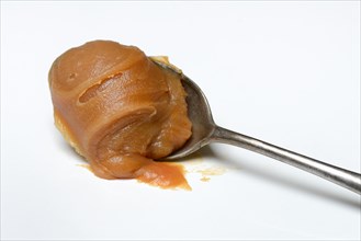 Salted caramel cream on spoon