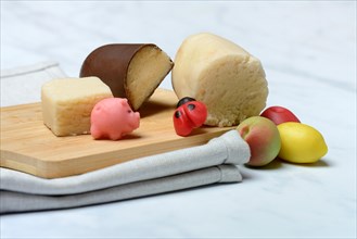 Marzipan and marzipan figures on wooden board