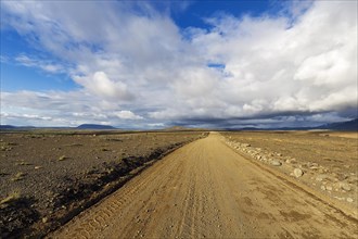 Lonely gravel road through volcanic landscape