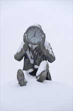 Sculpture holding a clock