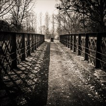 Old metal bridge for pedestrians in a forest