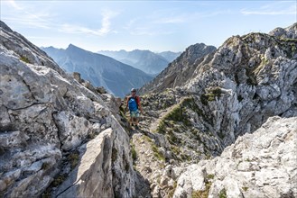 Mountaineer climbs a secured via ferrata