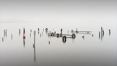 An old jetty in dense fog in the Kleiner Schwielochsee