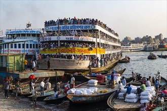 Overloaded passenger ferry with pilgrims on the Dhaka river