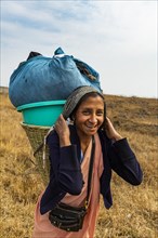 Khasi woman carrying the laundry to a creek in a traditional basket