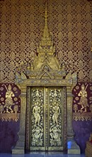 Splendid entrance door with carved half reliefs and decorative ornaments