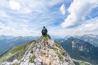 Mountaineer on a ridge on a secured via ferrata