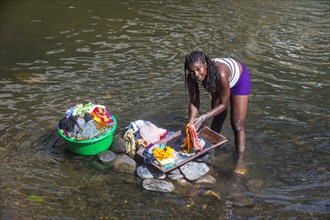 Woman washing her clothes in a river at the east coast of Sao Tome