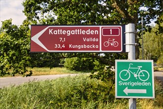 Signpost with pictogram bicycle for Swedish cycling routes Kattegattleden and Sverigeleden