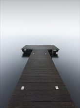 A jetty in dense fog in the Kleiner Schwielochsee