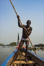 Man pushing his small boat on Banana islands