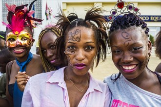 Happy girls posing at the Carneval in the town of Sao Tome
