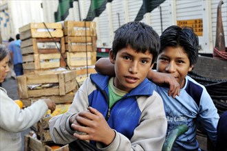 Two boys working as carriers at the fruit market Mercado de Frutas, La Victoria district, Lima, Peru
