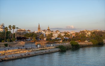 Waterfront Muelle de la sal at the river Rio Guadalquivir with Monumento a la Tolerancia