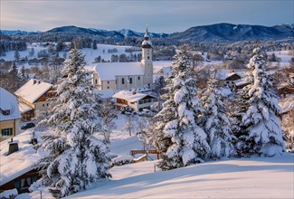 Village view with parish church in early morning light