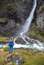 Hiker looks at Svoufallet waterfall