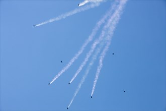 Parachutes in free fall with a smoke trail