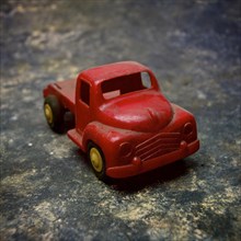 Old red plastic toy car