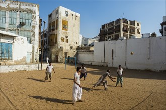 Men playing volleyball in the old town of Jeddah