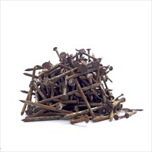 Pile of rusty steel nails on white background