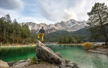 Young man standing on a rock on the shore