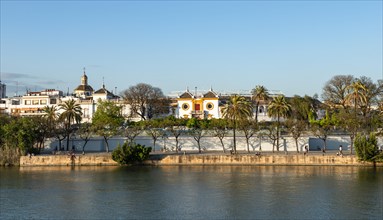 View over the river Rio Guadalquivir to the bullring Plaza de toros de la Real Maestranza de Caballeria de Sevilla