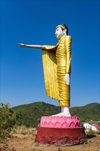 Large standing buddha on a hill