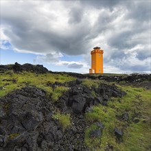 Orange lighthouse Skalasnagaviti or Svoertuloft at cliff