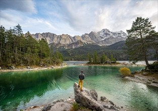 Young man standing on a rock on the shore