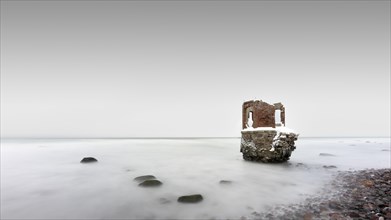 Old tide gauge house on the beach near Kap Arkona on the German island of Ruegen