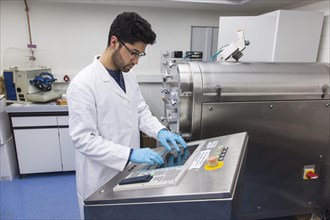 Scientists during their research work on a tablet press at the Institute for Pharmaceutical Technology and Biopharmacy at Heinrich-Heine-University Duesseldorf