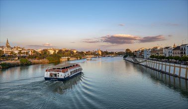 View over the river Rio Guadalquivir with excursion boats