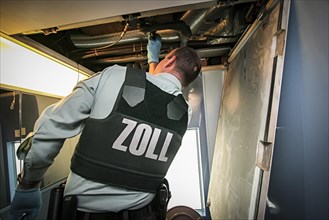 Customs officer searches for contraband and narcotics in ICE train on Rhine Valley route to Switzerland