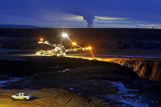 Opencast lignite mine with stacker in the evening