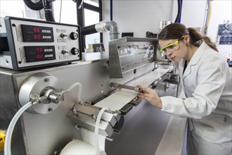 Doctoral student during her research work on a film drawing bench at the Institute for Pharmaceutical Technology and Biopharmacy at Heinrich-Heine-University Duesseldorf
